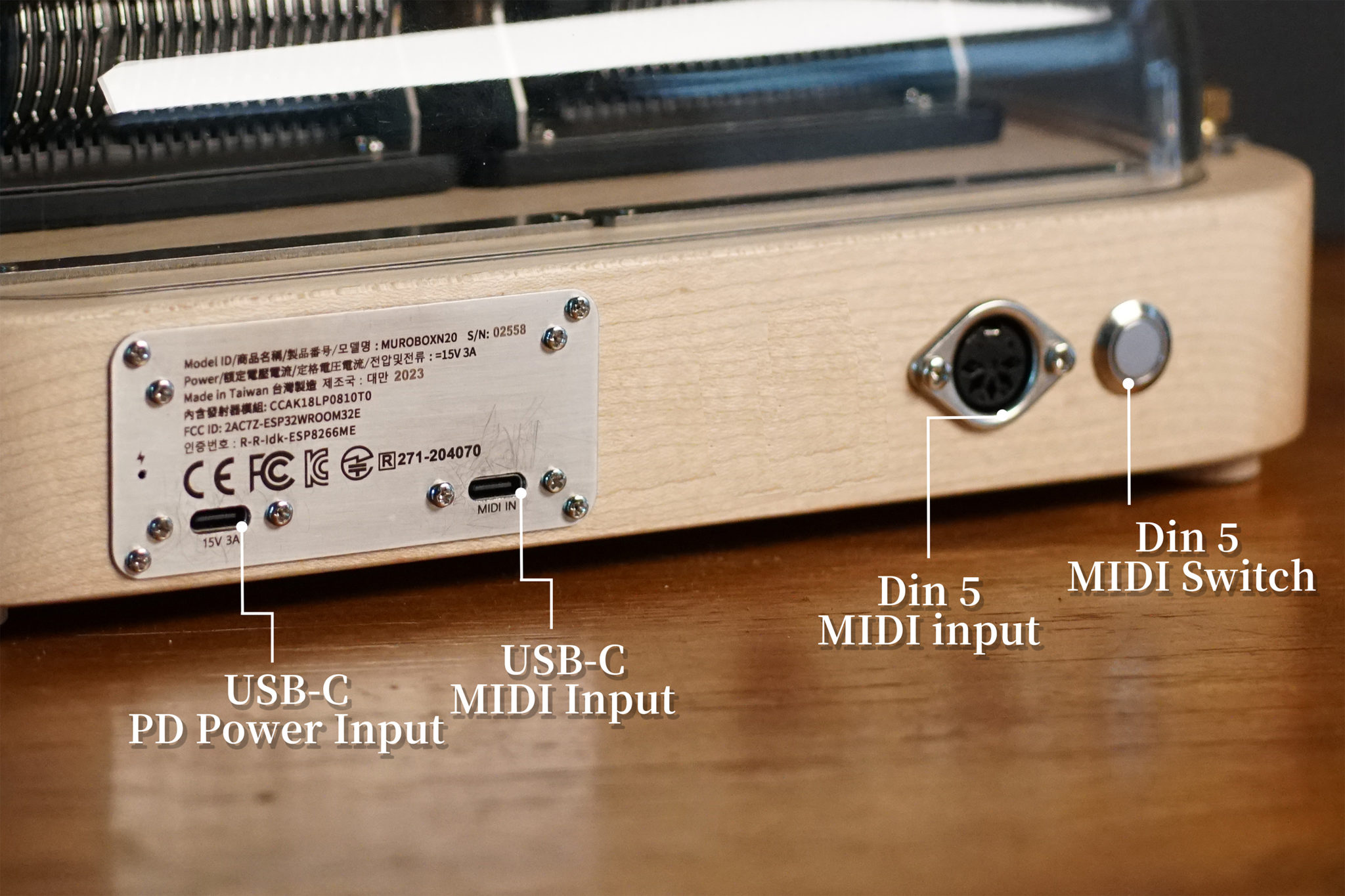 The back side of Muro Box-N40 Standard music box shows a power input slot and a MIDI input slot both are type-C on the metal plate. There is also a Din 5 MIDI input slot and a button to receive the midi message from the Din 5 MIDI input cable.