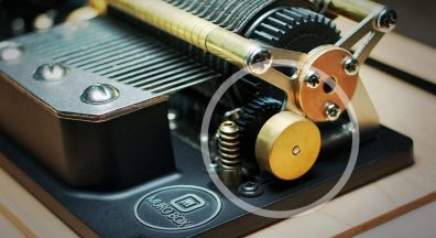 A close-up photo of the brass flywheel on the Muro Box-N40 Standard music box.